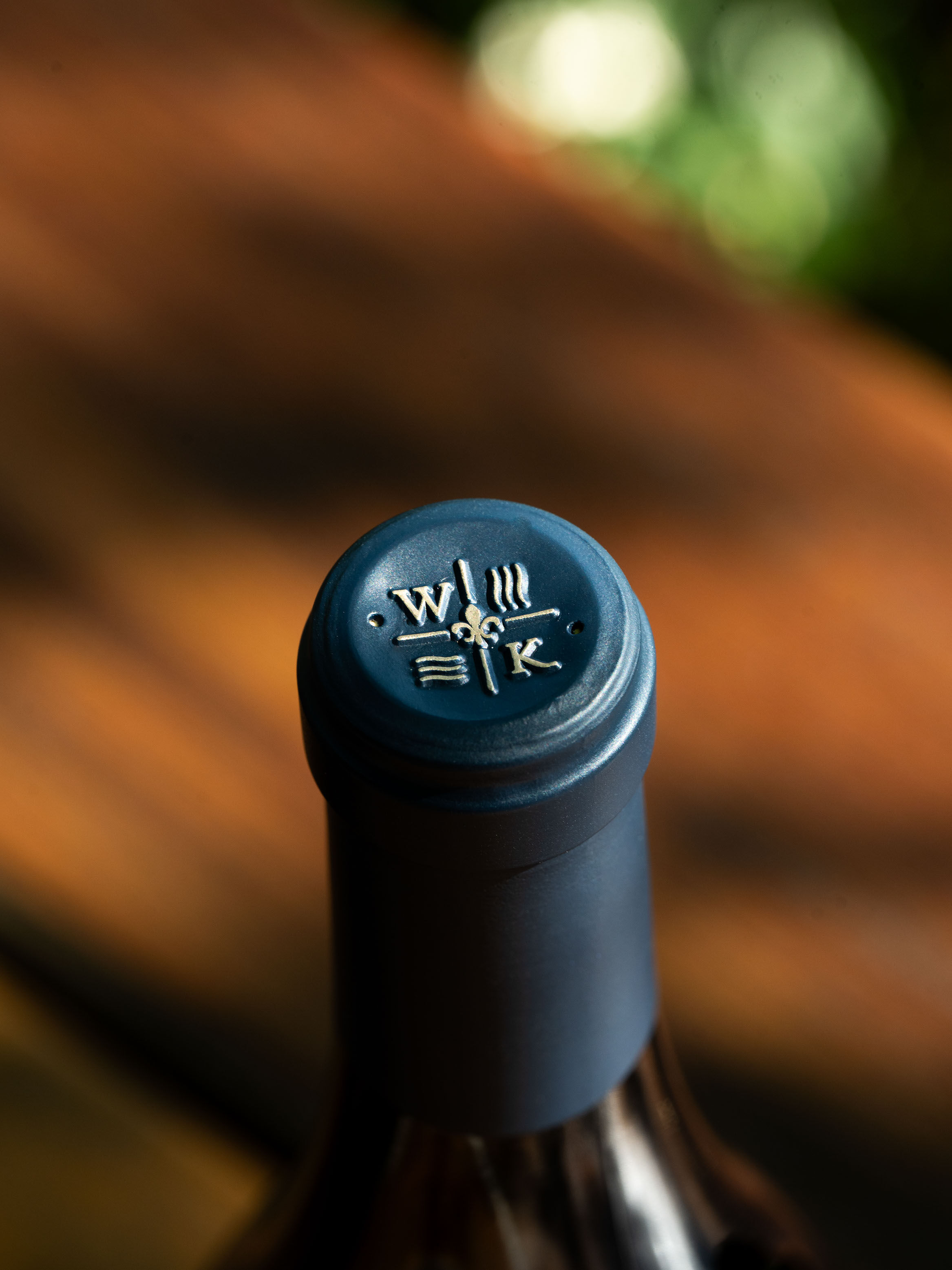 Two glasses and 2 bottles of rosé sitting on a bar in the WillaKenzie Tasting room.