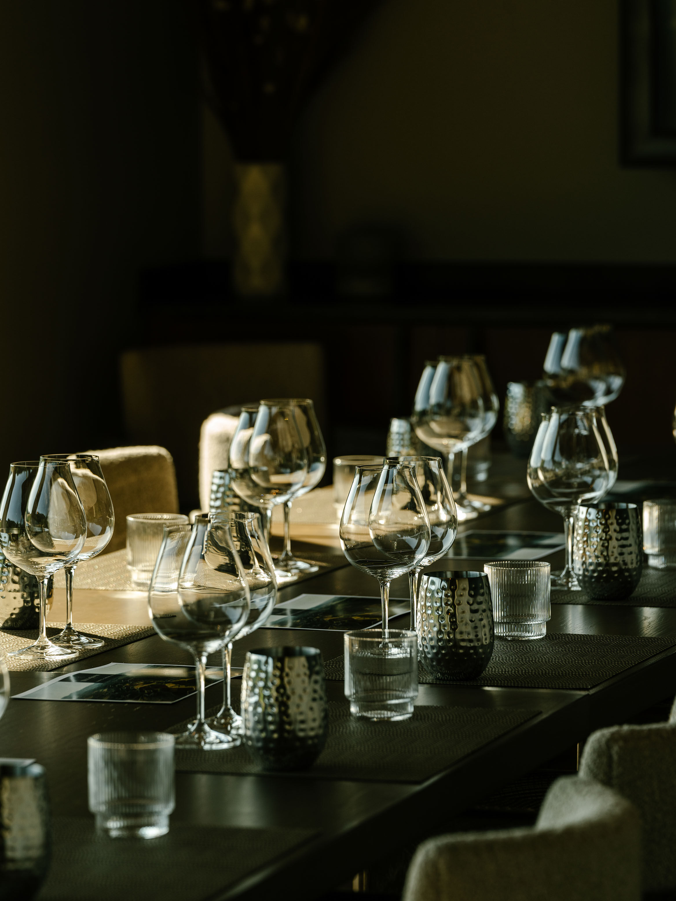 Various bottles of wine at WillaKenzie on wooden table in the estate lounge.
